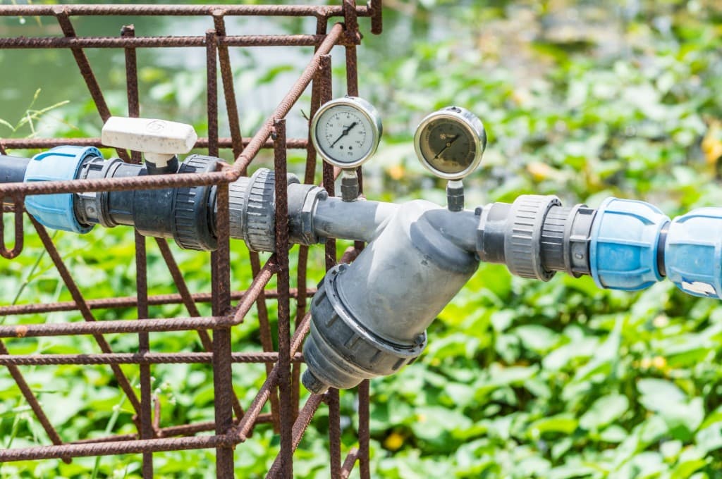 Agricultural irrigation gauges and valves in a field setting